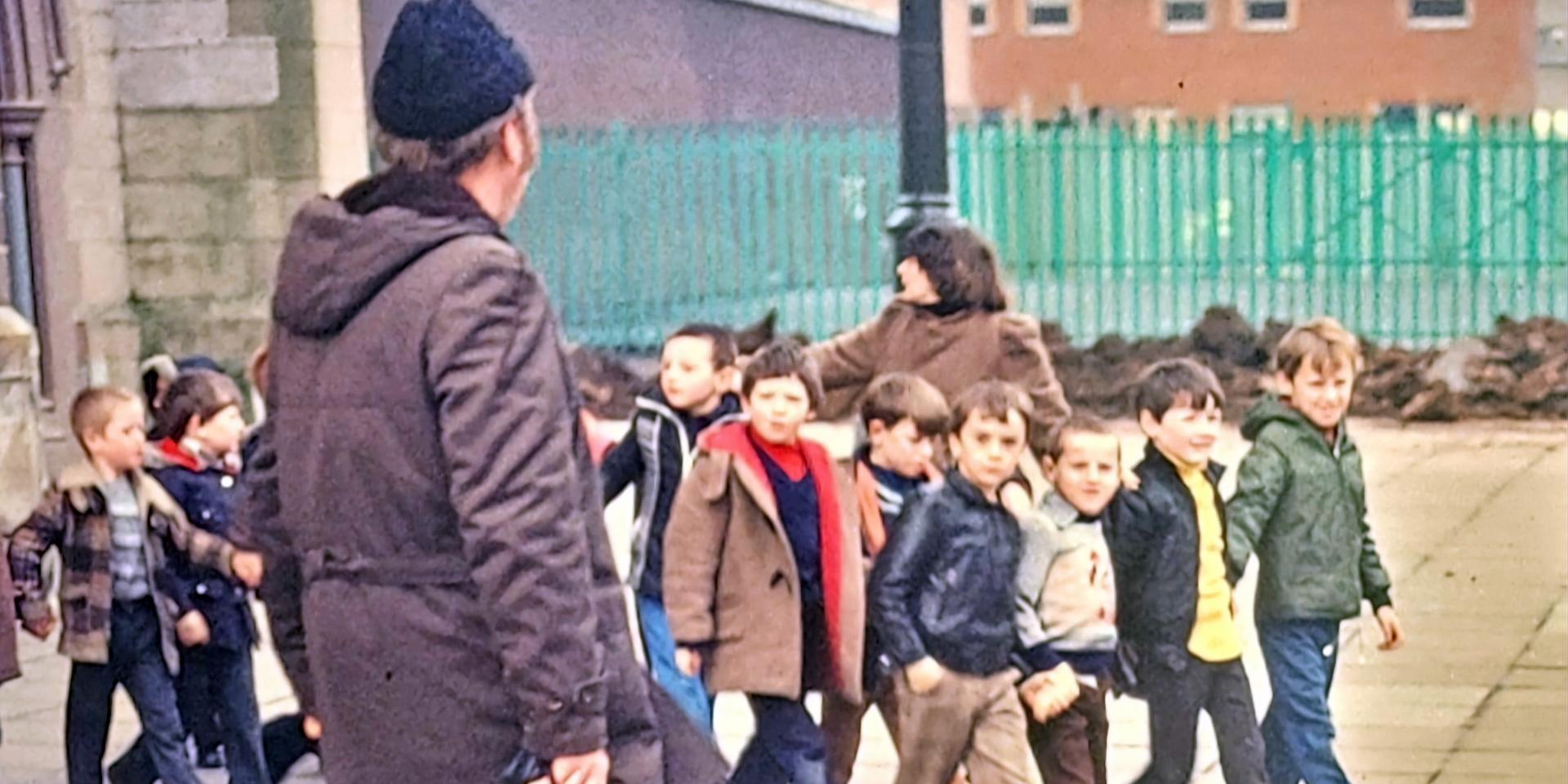 Der frühere Euskirchener Caritas-Geschäftsführer und Vize-Landrat Bruno Grobelny mit Kindern auf einem Belfaster Schulhof der siebziger Jahre. 20 Jahre lang holten er und seine Mitstreiter Ferienkinder von hier in die Eifel.