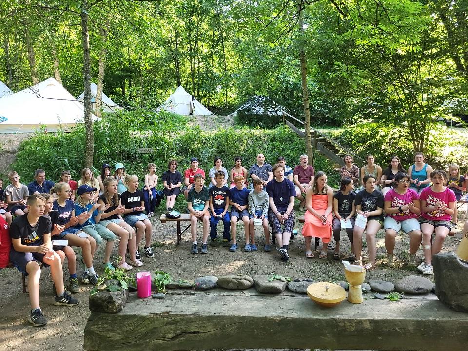 Blick vom Altar auf einen Teil der Open-Air-Gottesdienstgemeinde im „Camp St. Agnes 2024“ zu Beginn der Sommerferien in Widdau an der Rur.