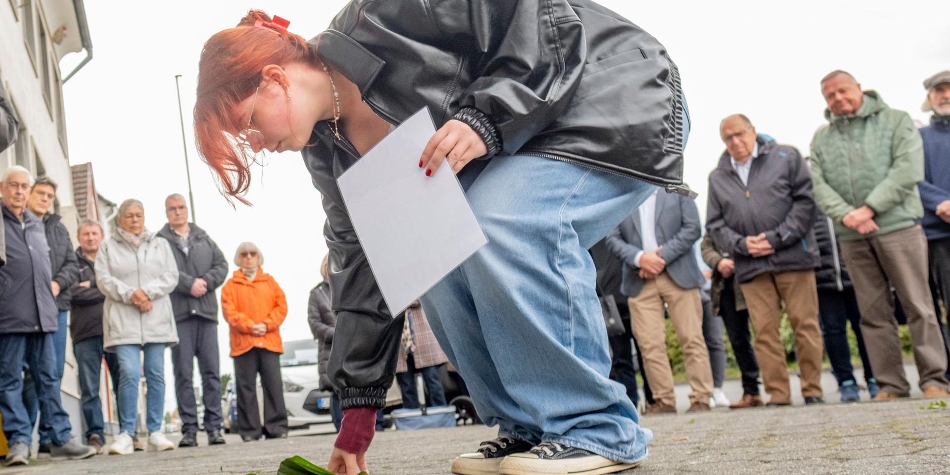 Eine Schülerin der Gesamtschule Mechernich legt eine Rose an die Stolpersteine von Dr. Robert und Bertha David, die in der Bahnstraße lebten. Insgesamt acht Gedenksteine wurden jetzt in Mechernich verlegt. Foto: Ronald Larmann/pp/Agentur ProfiPress